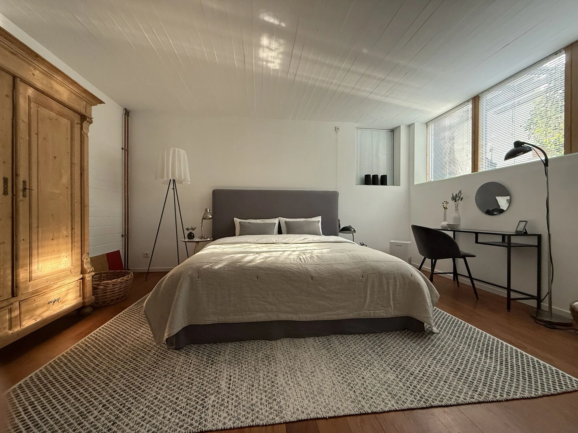Schlafzimmer der Ferienwohnung RÖWE 54 mit Kingsize-Bett, Leuchten und Fensterband